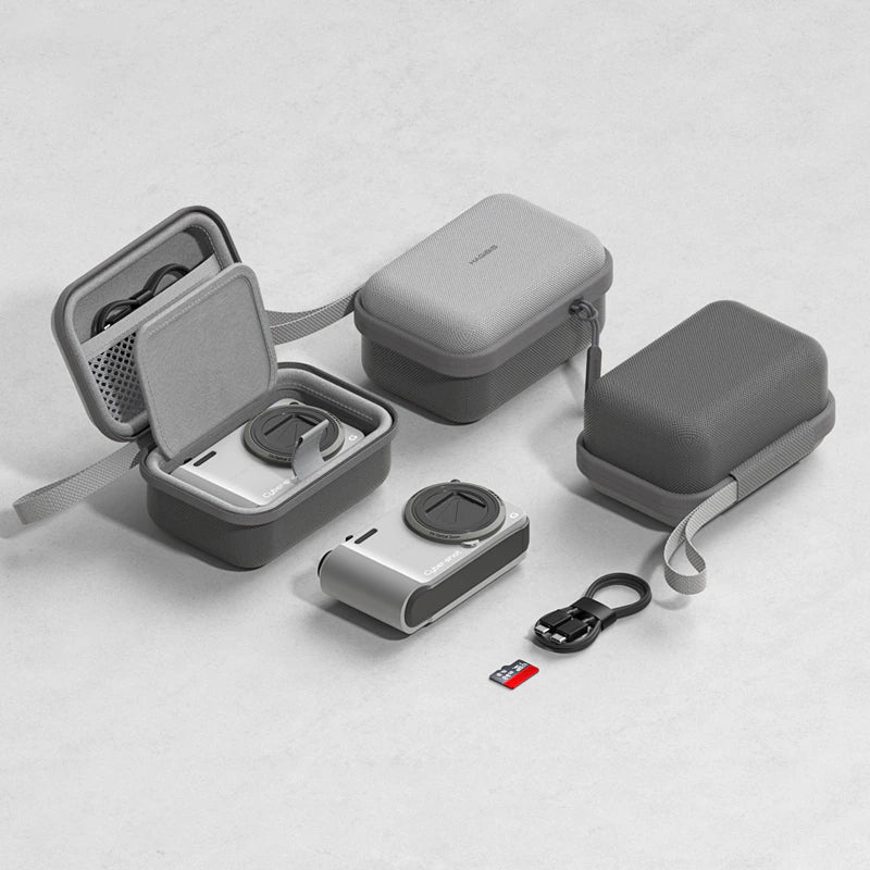 Gray protective camera gear case set shown on a light gray background, including an open case with accessories inside, a closed case, a strap, a small camera lens, a USB cable, and an SD card.