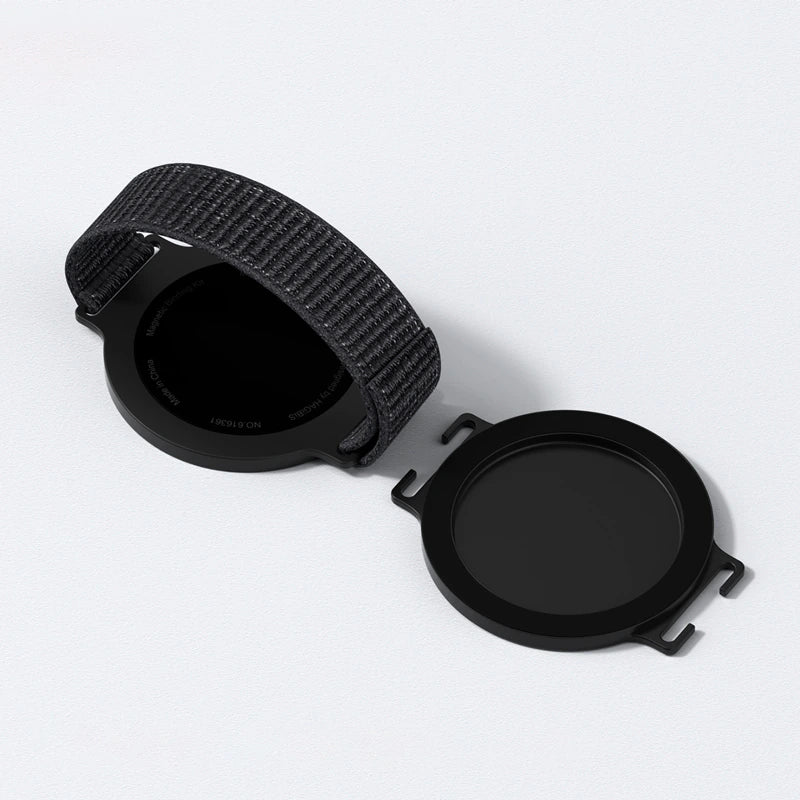 A black smartwatch band with a textured woven pattern, shown partially uncoiled next to its matching black circular protective case on a clean white background.