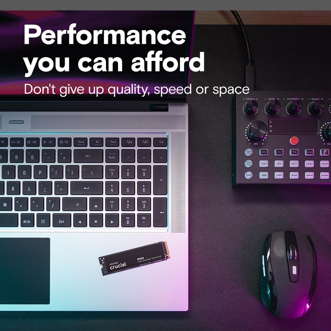 Laptop with keyboard, mouse, and memory stick on a dark surface with text about performance.