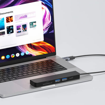 Laptop with a USB hub attached on a white background