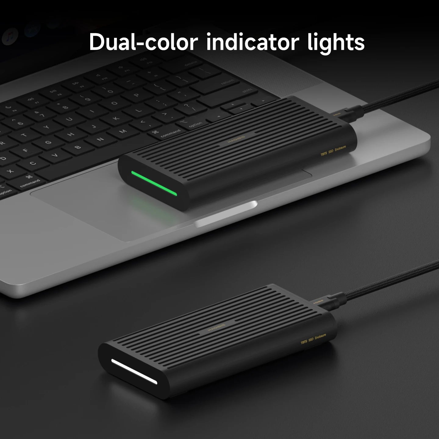 Black USB hub with dual-color indicator lights on a laptop keyboard