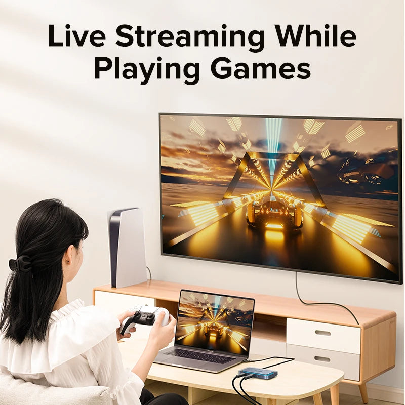 Person live streaming while playing games on a laptop and TV.