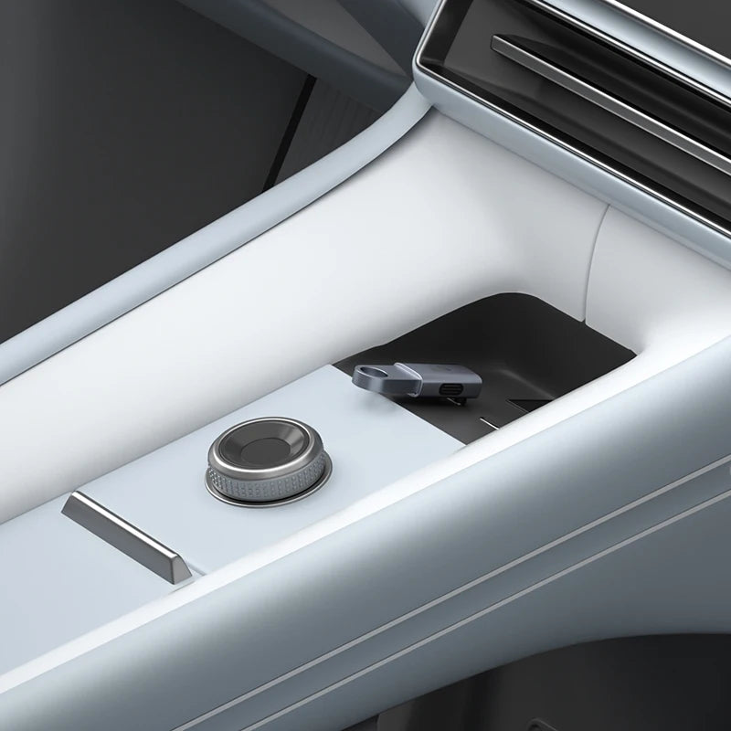 Close-up of a car's cup holder and gear shift area with a white interior.
