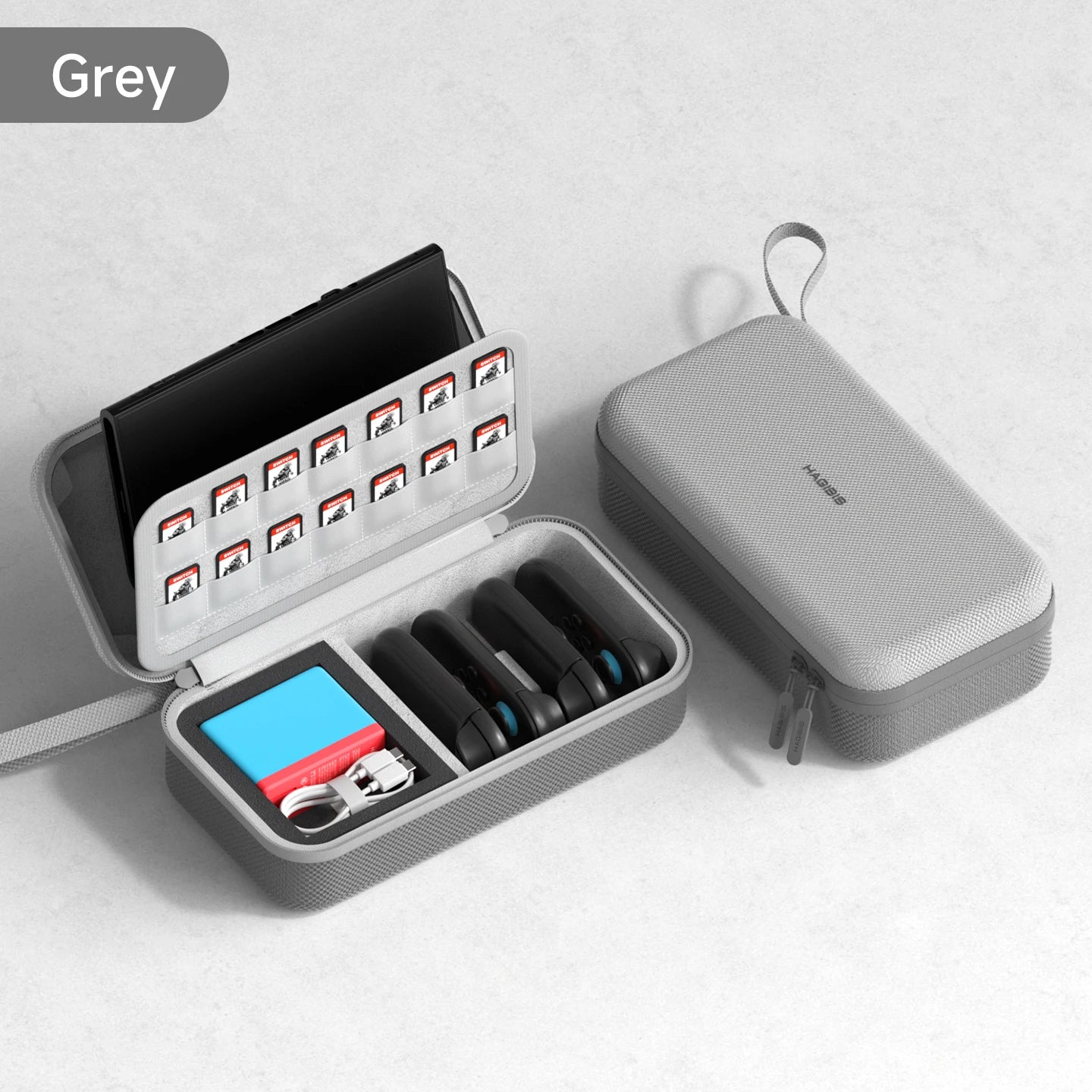 Gray travel case with open compartment containing small items on a light gray background