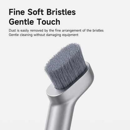 Silver cleaning brush with fine soft bristles on a white background