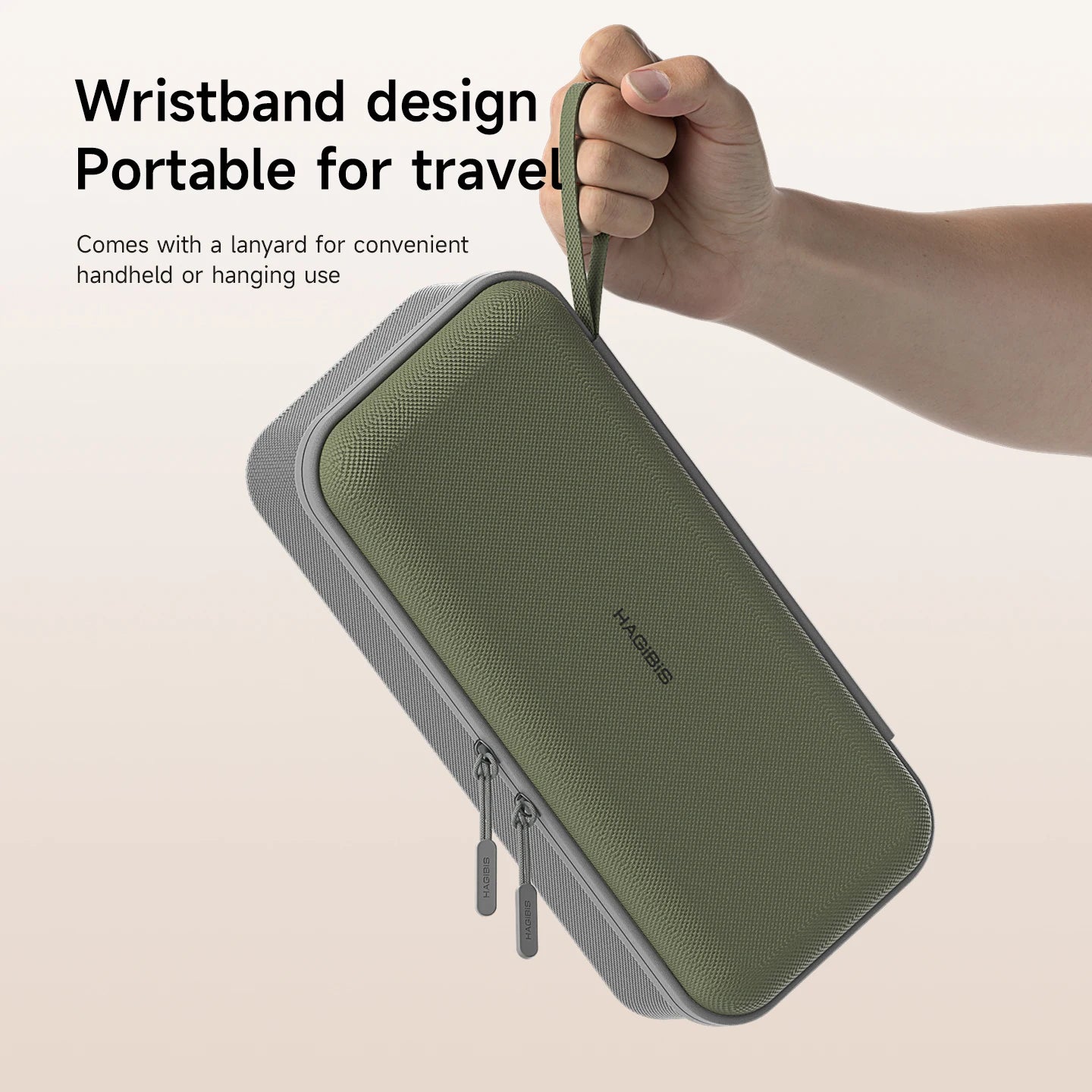 Green travel case with wrist strap held by a hand on a beige background