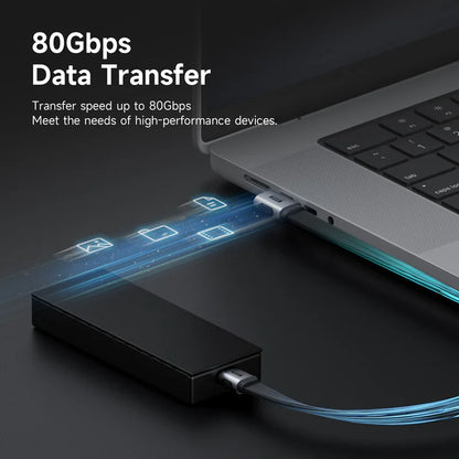 Laptop with external hard drive connected, showcasing 80Gbps data transfer capability.