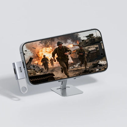 Phone with screen magnified by a stand, showing a war scene with soldiers and explosions.