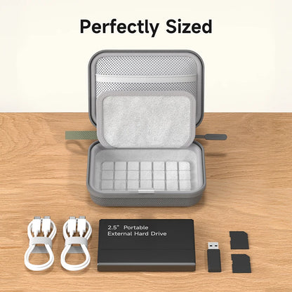 Gray portable external hard drive case with accessories on a wooden surface