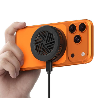 A hand holding an orange smartphone case with a black circular cooling fan attached to its back, connected to a black charging cable, on a white background.