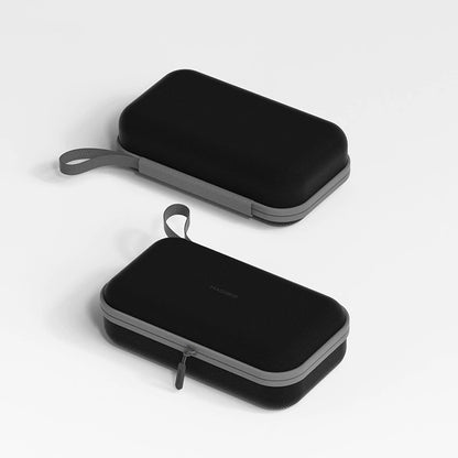 Two black carrying cases with gray handles on a light gray background
